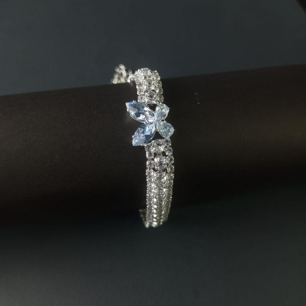 Silver ring with a blue gemstone on a black background